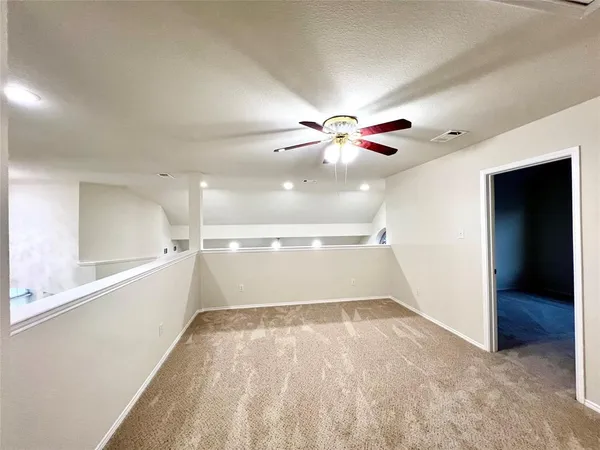 wooden floor in an empty room with a ceiling fan