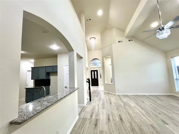 a view of a kitchen with a sink and cabinets