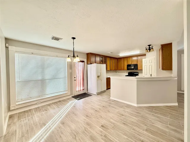 a view of a kitchen with wooden floor and a kitchen