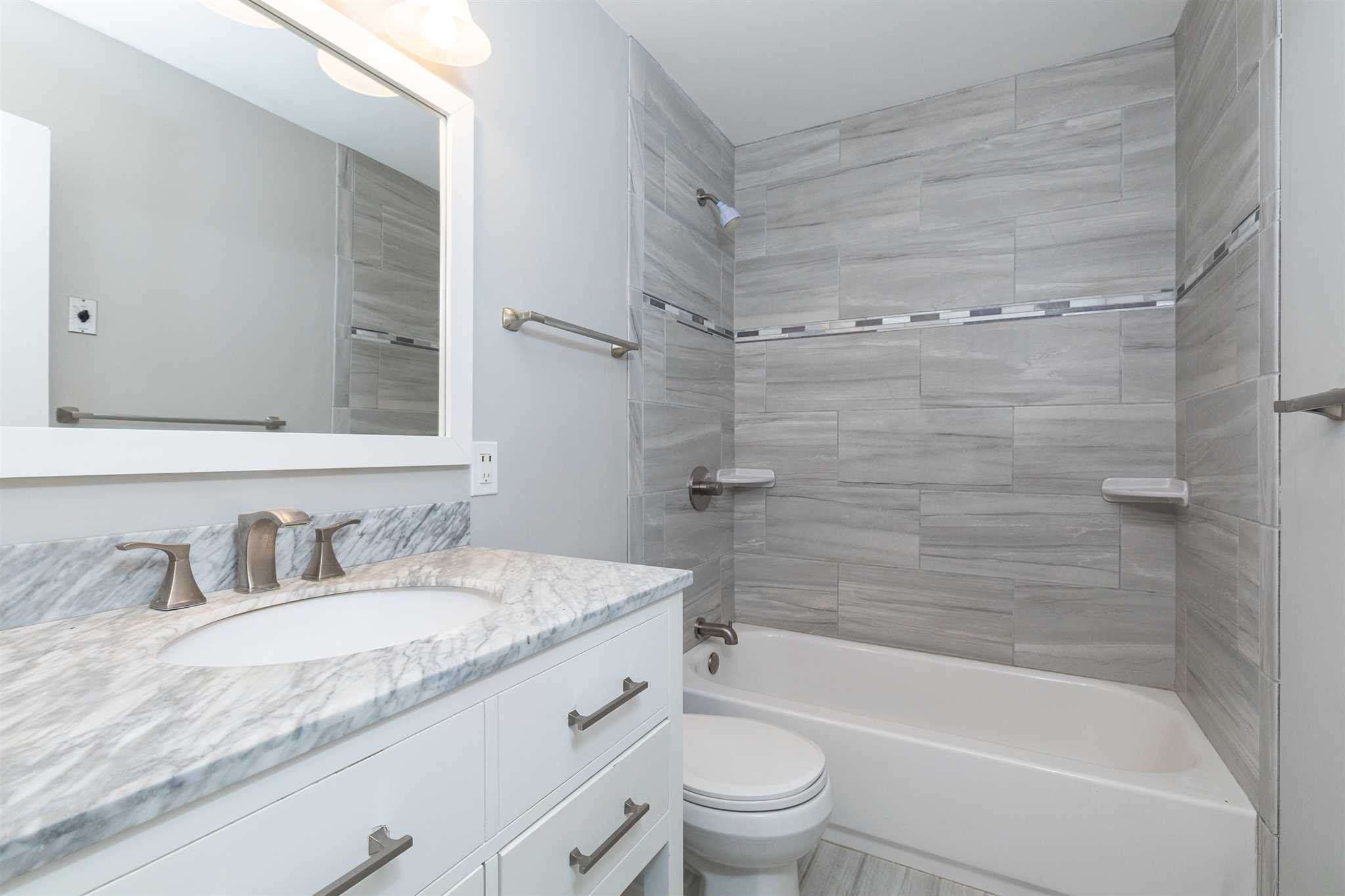 29 Milano Drive LaGrange, NY 12603 - Photo 11 of 21 a bathroom with a granite countertop bathtub shower sink vanity mirror and toilet