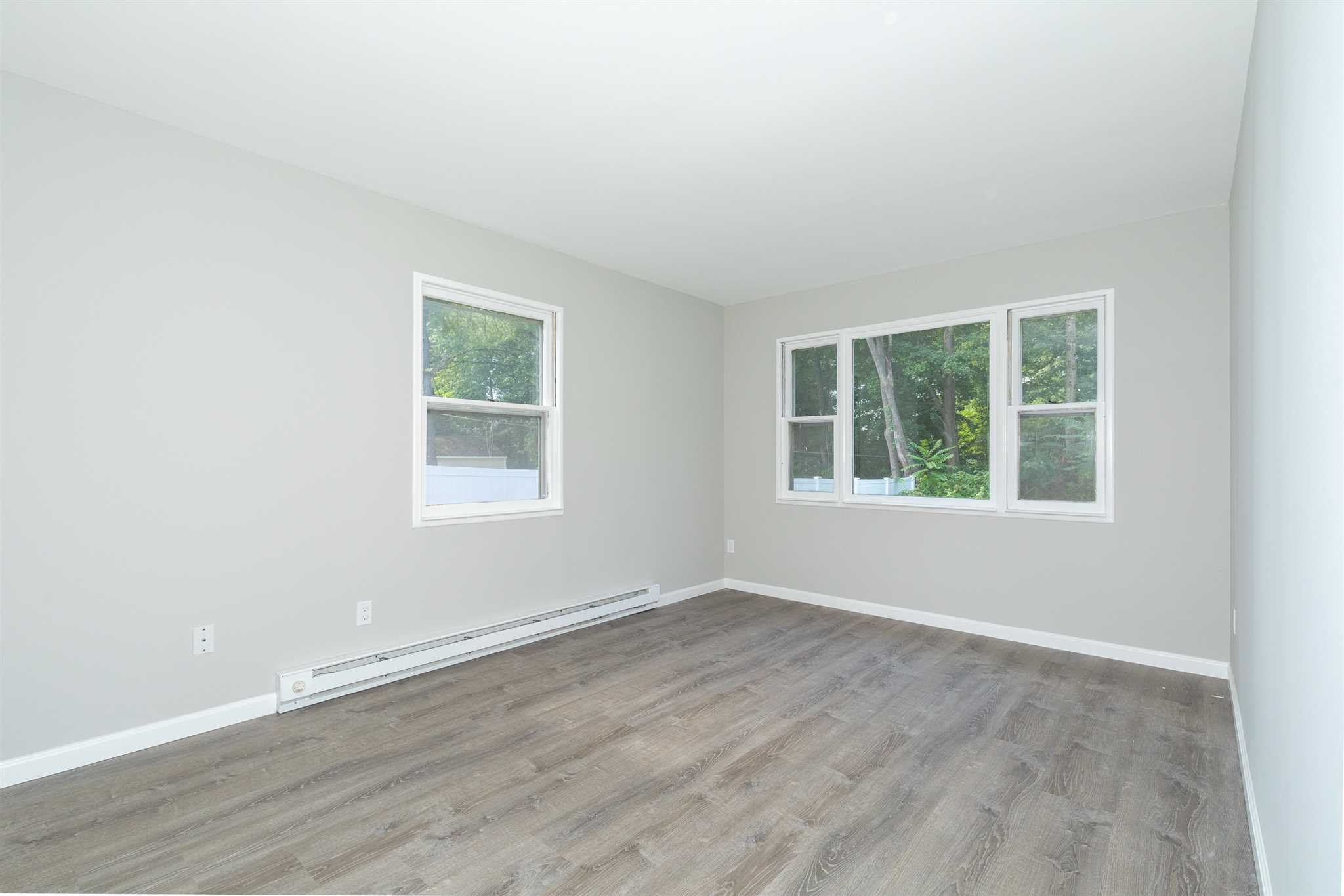29 Milano Drive LaGrange, NY 12603 - Photo 14 of 21 an empty room with wooden floor and windows