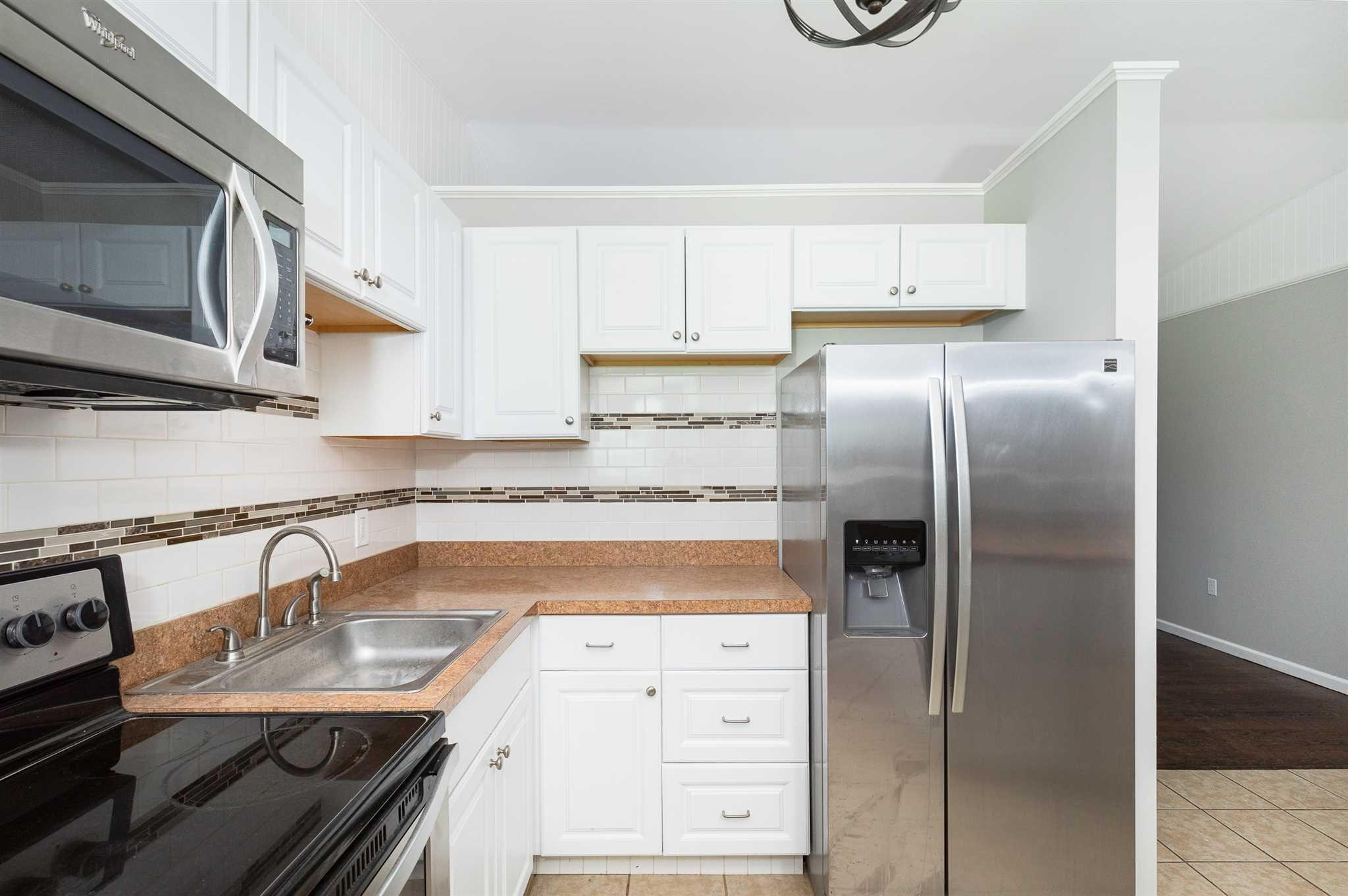 29 Milano Drive LaGrange, NY 12603 - Photo 5 of 21 a kitchen with stainless steel appliances granite countertop a refrigerator a stove and a sink with wooden floor
