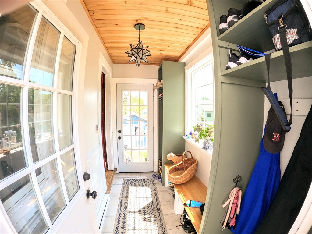 12 Searle Road, Unit 12 Boston, MA 02132 - Photo 20 of 35 a view of an entryway with wooden floor and a chandelier