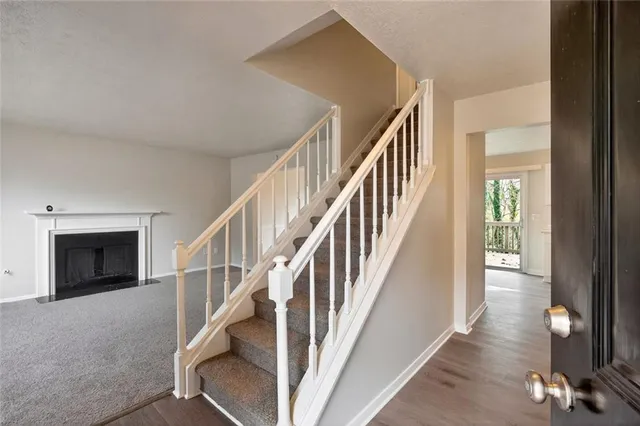 a view of entryway and hall with wooden floor
