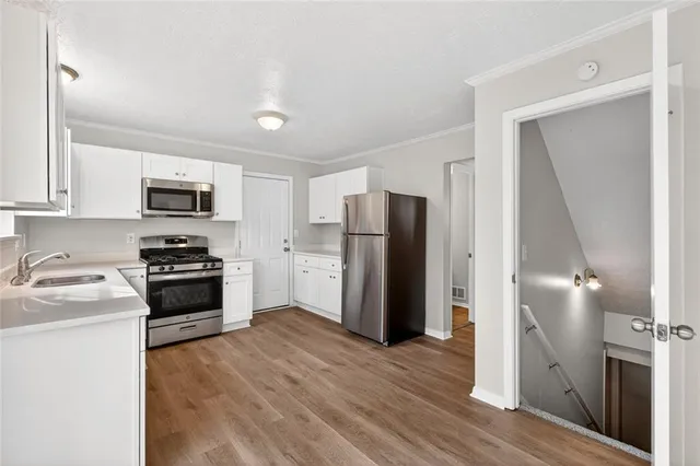 a kitchen with a refrigerator a stove top oven a sink and dishwasher