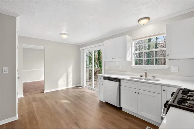 a kitchen with a sink stove and cabinets