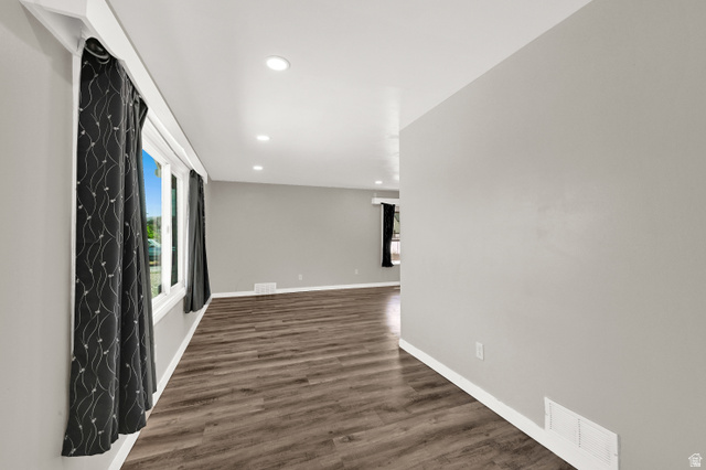 716 East Factory Street Garland, UT 84312 - Photo 4 of 30 Spacious room featuring wood-finish flooring, recessed lighting, neutral wall tones, and white trim