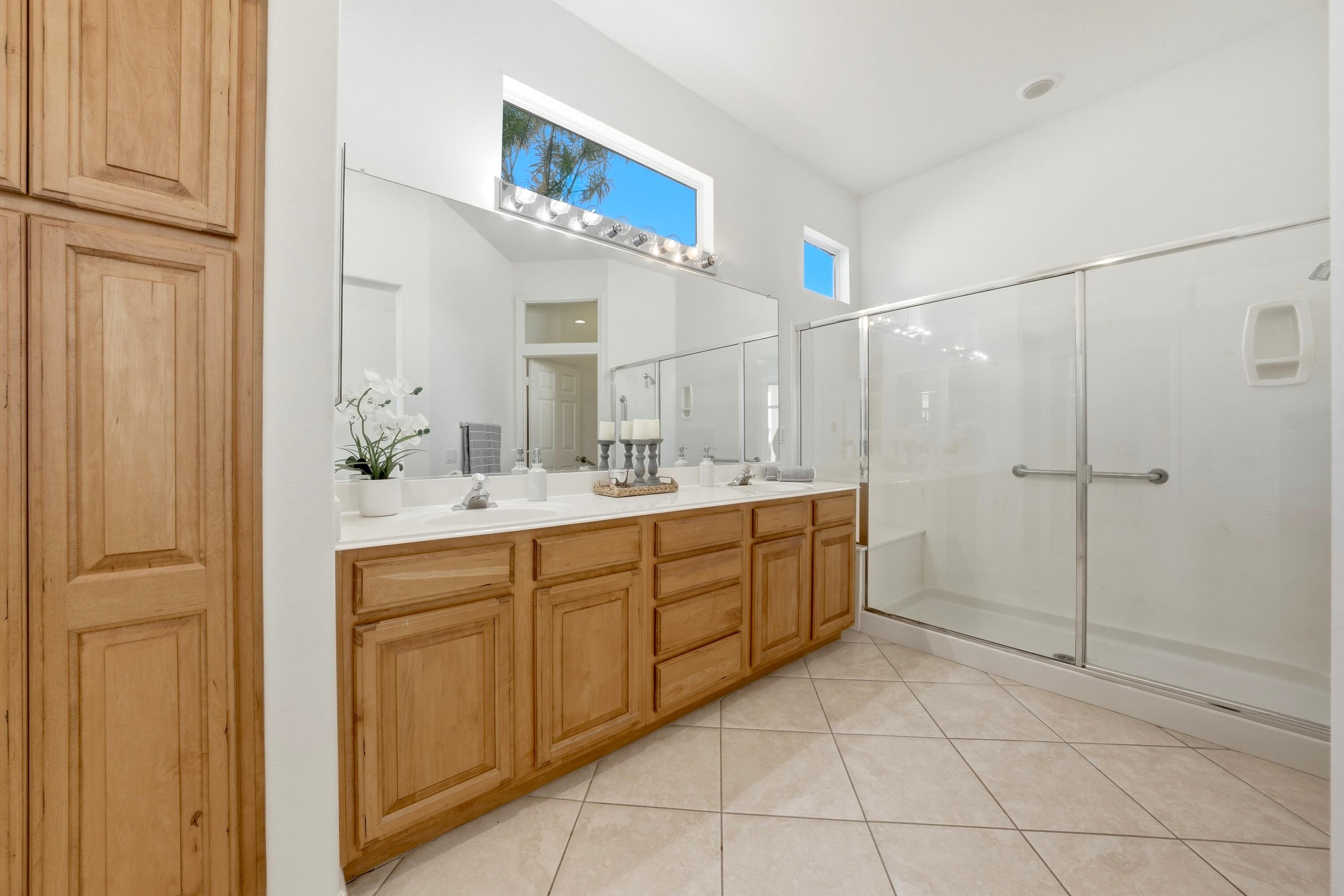 35440 Moorbrook Road Palm Desert, CA 92211 - Photo 23 of 32 a bathroom with a sink a mirror and a shower