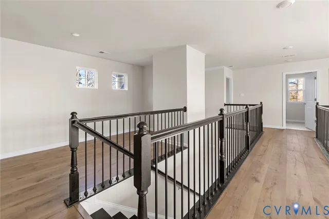 a view of staircase with wooden floor and window