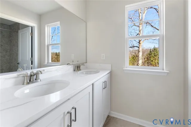 a bathroom with a double vanity sink and a window