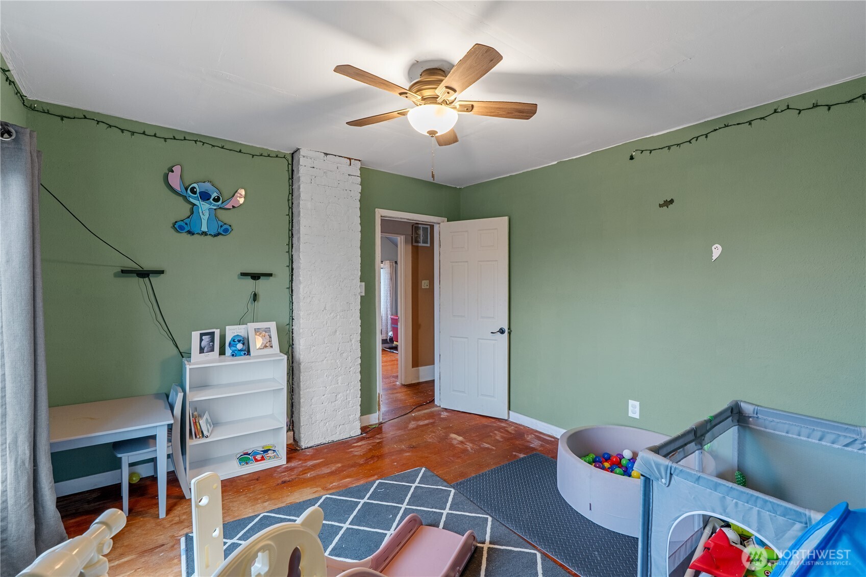 619 Spruce Street Hoquiam, WA 98550 - Photo 21 of 30 a bedroom with a bed and a chandelier