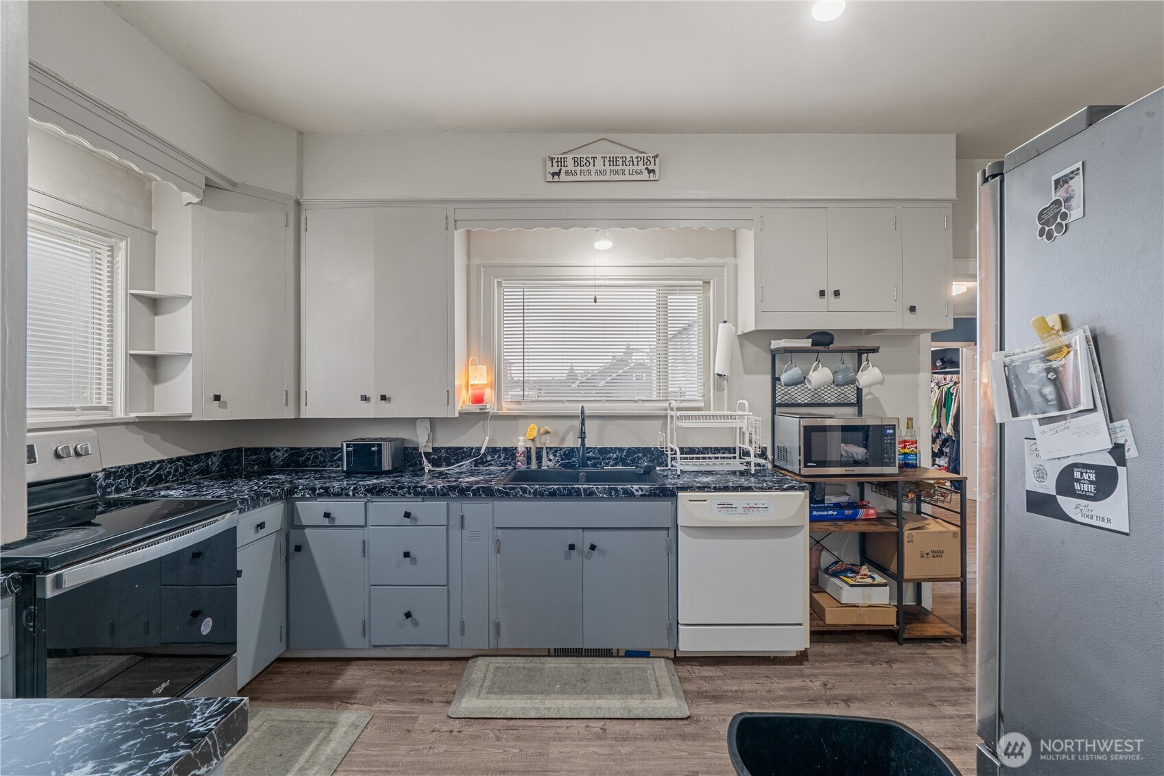 619 Spruce Street Hoquiam, WA 98550 - Photo 5 of 30 a kitchen with stainless steel appliances granite countertop a stove a sink and a refrigerator