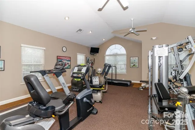 a view of a workspace with furniture and a bookshelf