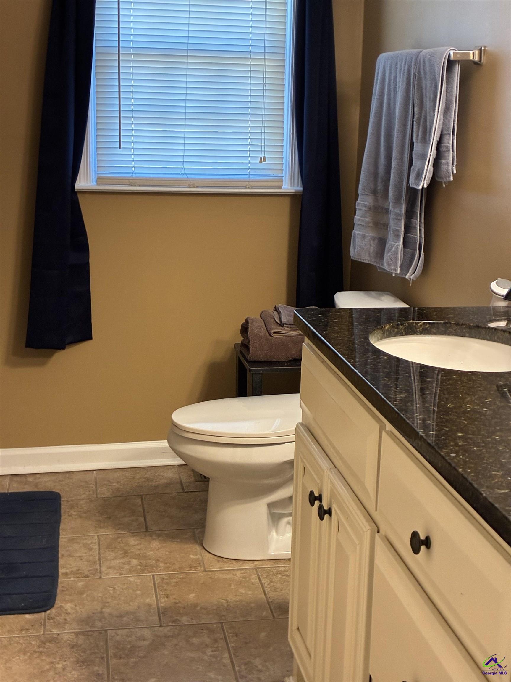 3491 Sandy Circle Macon, GA 31216 - Photo 27 of 47 a bathroom with a granite countertop toilet and a sink