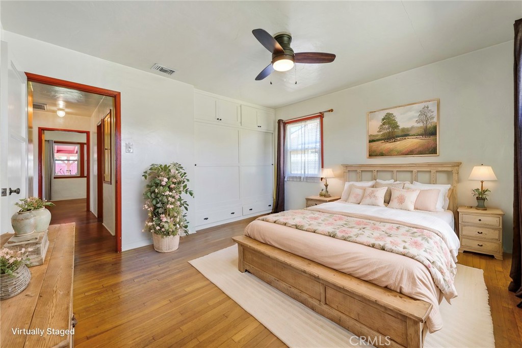 4660 Cover Street Riverside, CA 92506 - Photo 11 of 45 a spacious bedroom with a bed and a chandelier