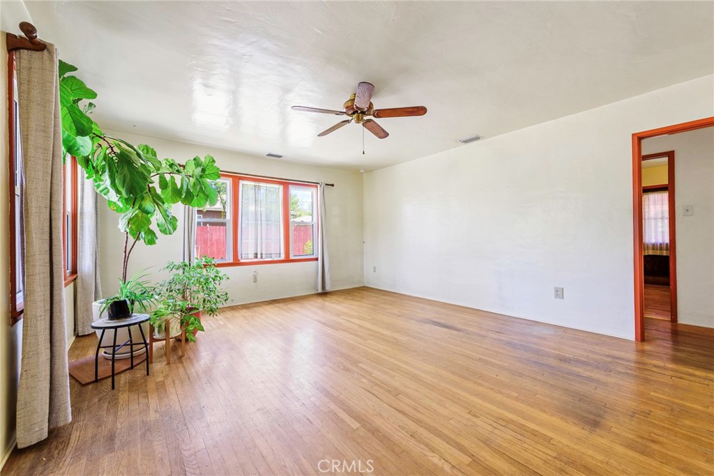 4660 Cover Street Riverside, CA 92506 - Photo 13 of 45 an empty room with wooden floor and windows