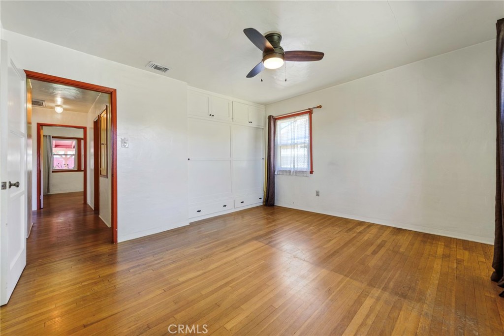 4660 Cover Street Riverside, CA 92506 - Photo 21 of 45 an empty room with wooden floor and windows