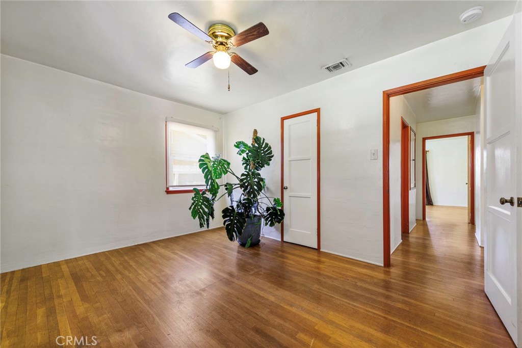 4660 Cover Street Riverside, CA 92506 - Photo 25 of 45 a view of an empty room and kitchen with wooden floor