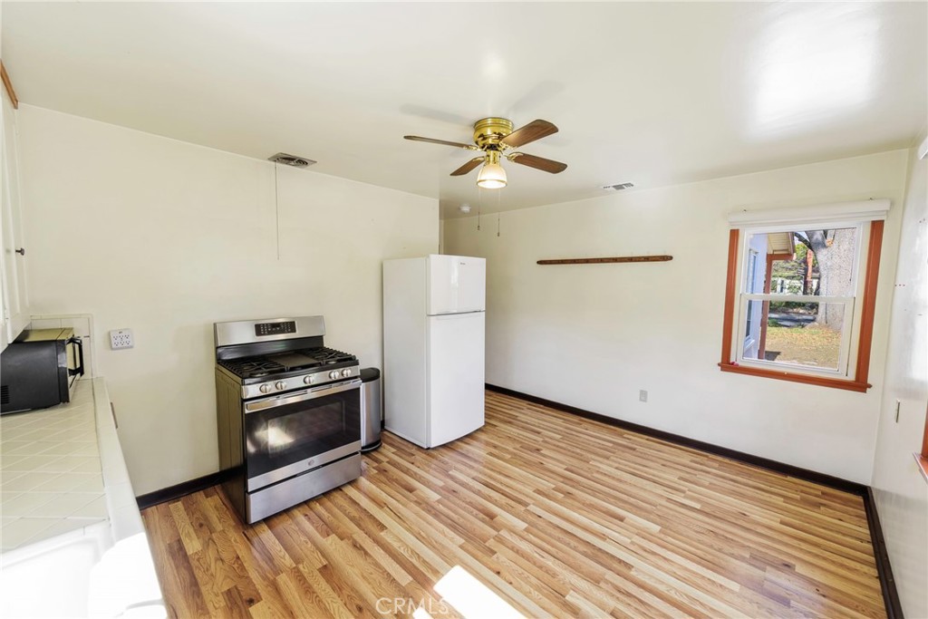 4660 Cover Street Riverside, CA 92506 - Photo 30 of 45 a living room with a couch and a ceiling fan