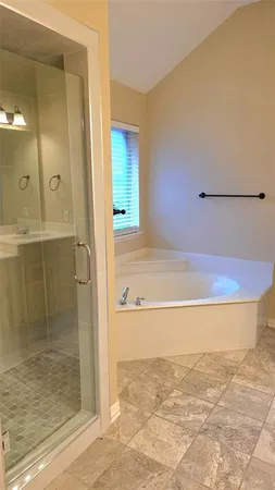 a bathroom with a bathtub and a shower