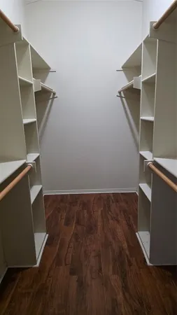an empty room with wooden floor and closet