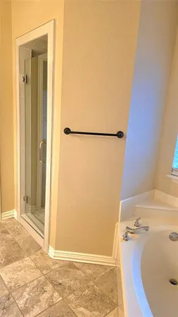 a view of a bathroom with tub and shower