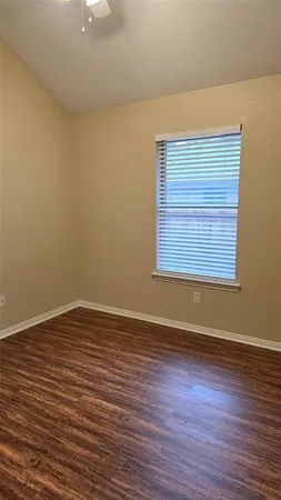 a view of room with window and wooden floor