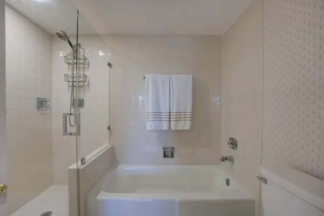 a bathroom with a bathtub and a shower