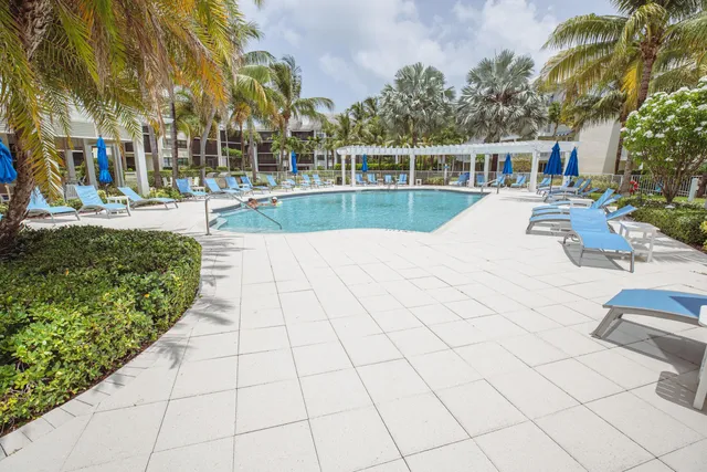a swimming pool with outdoor seating and yard