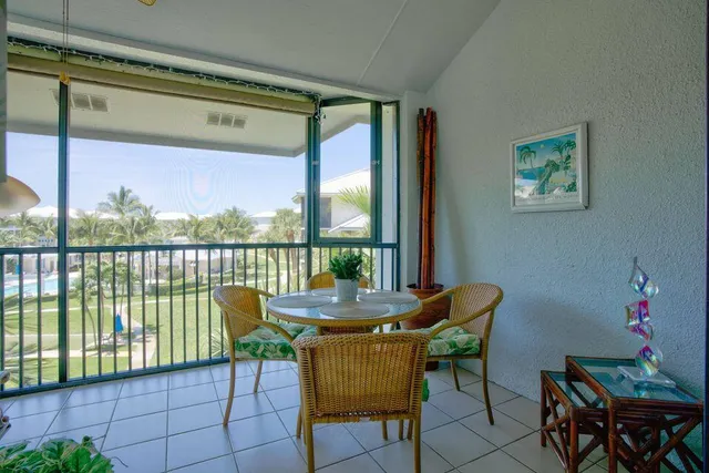 a dining room with furniture and a floor to ceiling window