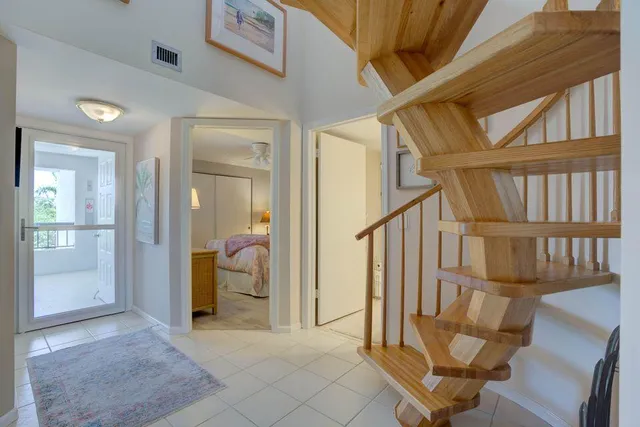 a view of an entryway with wooden floor and a livingroom view