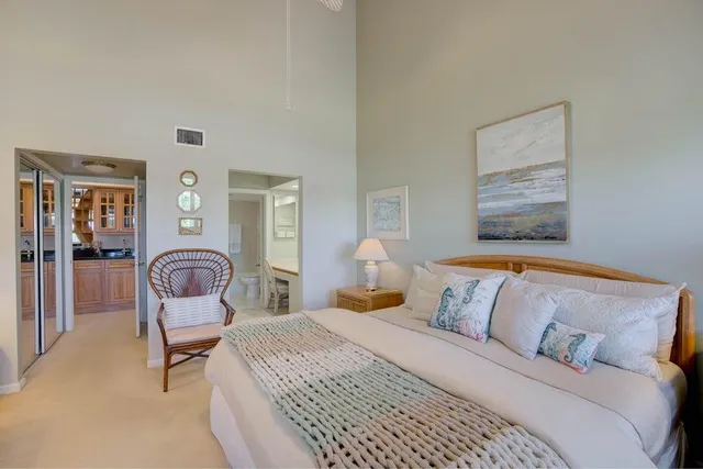 a bedroom with a large bed and dresser