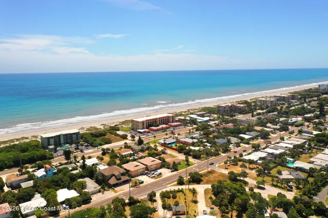 a living room with furniture kitchen view and a flat screen tv