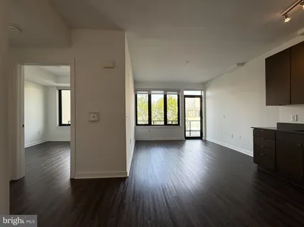 a view of a livingroom with wooden floor and a flat screen tv