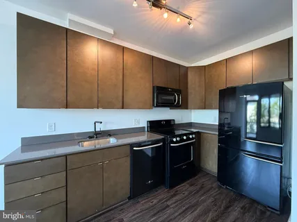 a kitchen with a sink stove and microwave