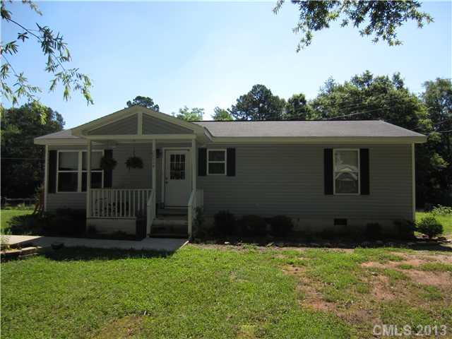 20116 Walter Henderson Road Cornelius, NC 28031 - Photo 2 of 15 a front view of a house with a garden