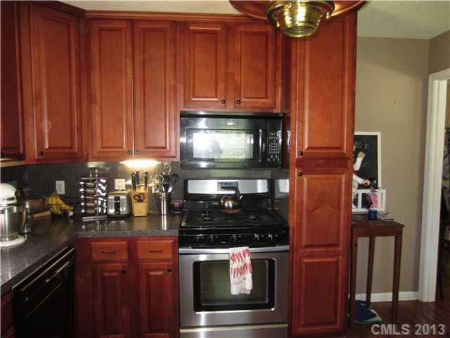 20116 Walter Henderson Road Cornelius, NC 28031 - Photo 3 of 15 a kitchen with stainless steel appliances granite countertop a stove and a microwave