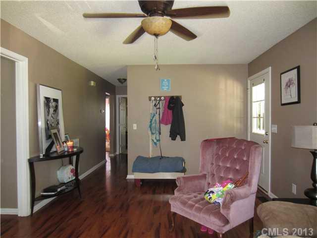 20116 Walter Henderson Road Cornelius, NC 28031 - Photo 5 of 15 a living room with furniture and a wooden floor