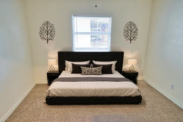 a bedroom with a bed and window