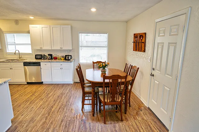 a view of a dining room with furniture and wooden floor