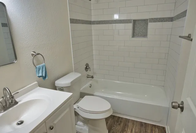 a bathroom with a toilet sink and bathtub
