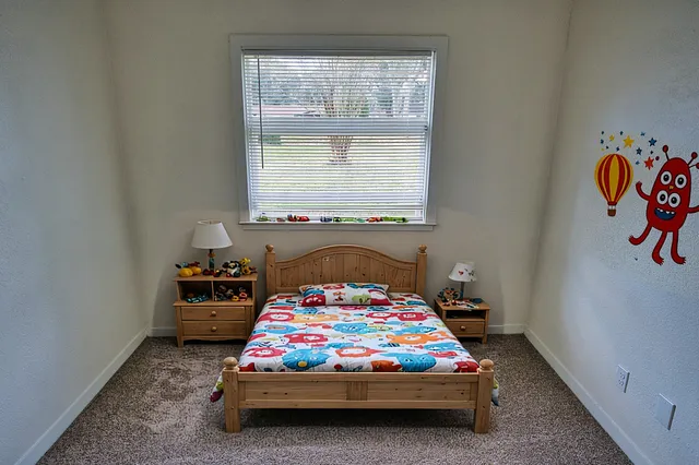 a bedroom with a bed and a window