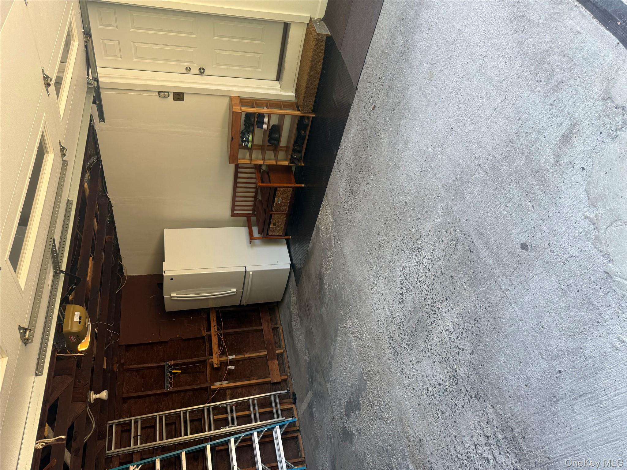 18 Adams Road Ossining, NY 10562 - Photo 29 of 41 Garage with fridge and a garage door opener