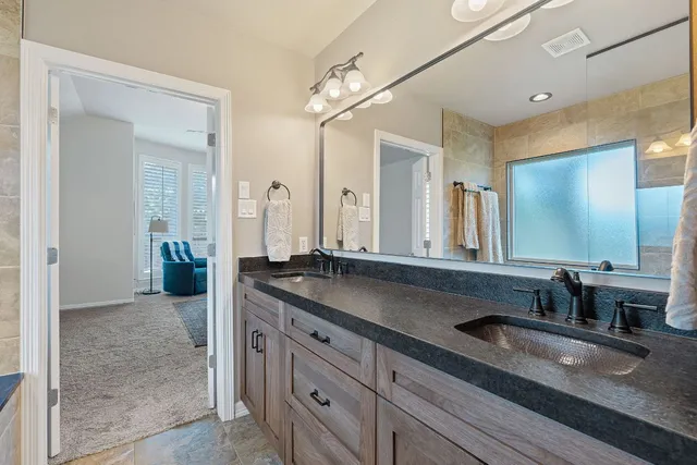 a bathroom with double sink and a mirror