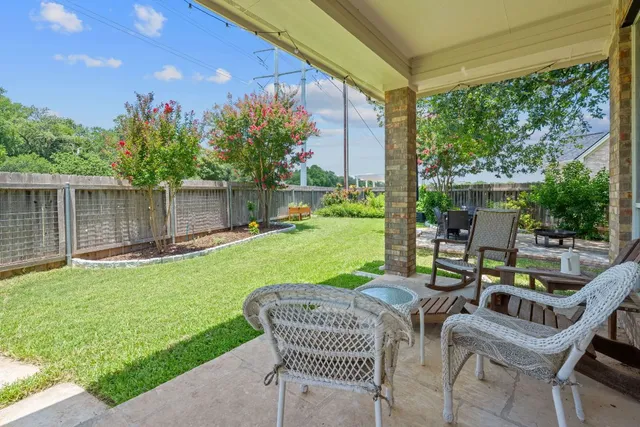 a view of a chair and tables in the backyard