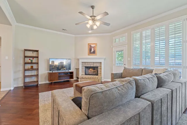 a living room with furniture a large window and a flat screen tv
