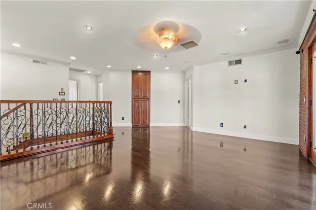 a view of a room with wooden floor