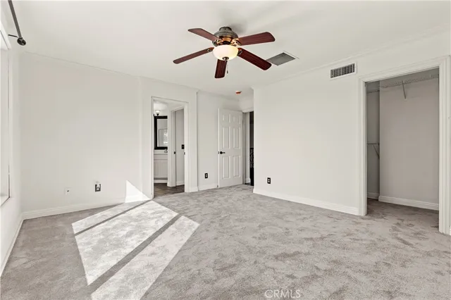 a view of empty room with ceiling fan