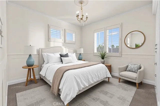 a bedroom with bed and a chandelier