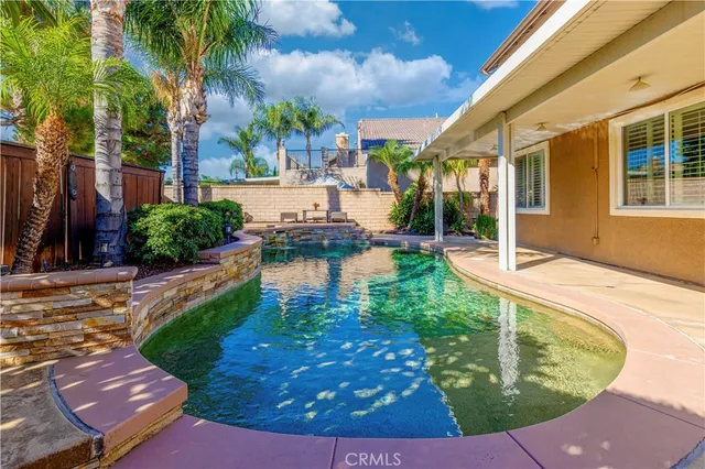 a view of a backyard with plants and patio